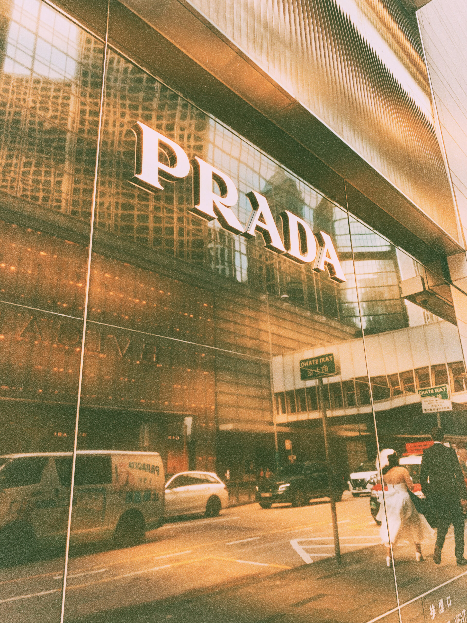 newly married couple passing by in Prada Store Central Hong Kong